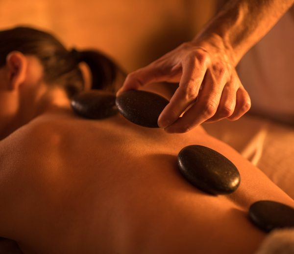 close up of hot stone therapy at the spa.